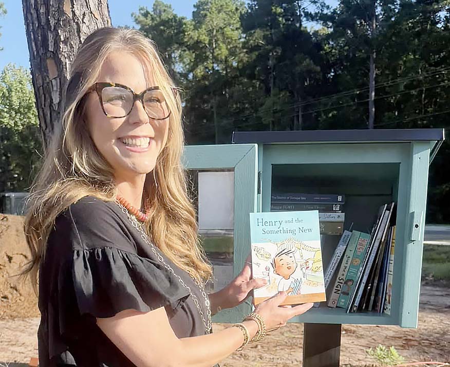 Adding books to Liberty County Kiwanis Lending Library