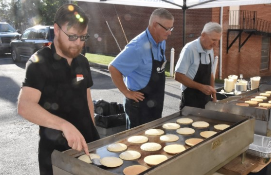 Club members and family members cook pancakes at the 2023 Pancake Breakfast.