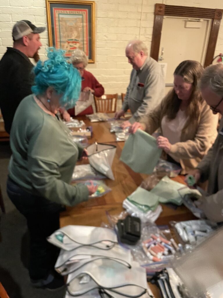 Volunteers prepare hygiene kits.