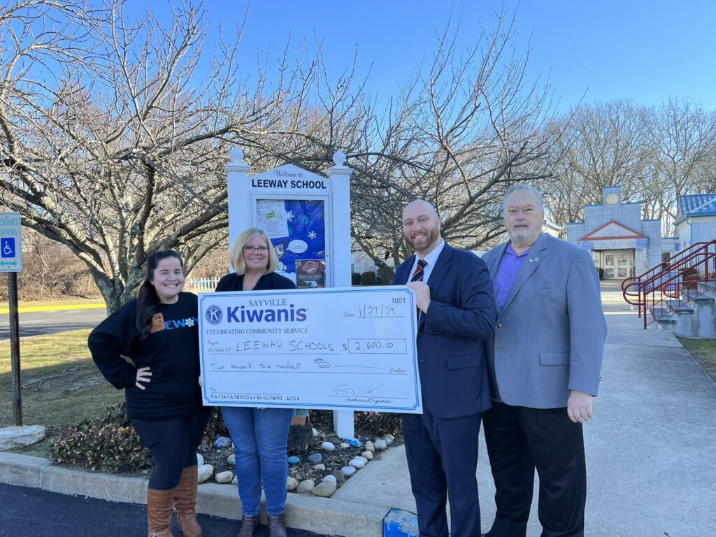 President Steven Blody and Michael Siniski present a check to the Leeway School