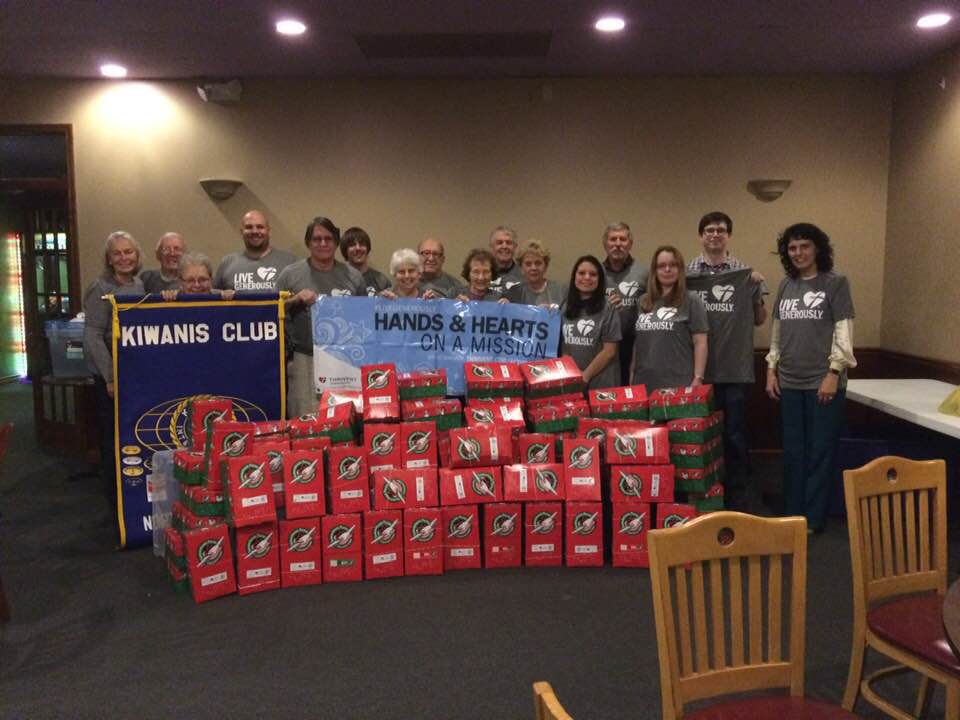 Group of people behind wrapped christmas presents