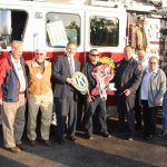 People standing in front of fire truck