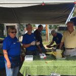 People standing around table at festival