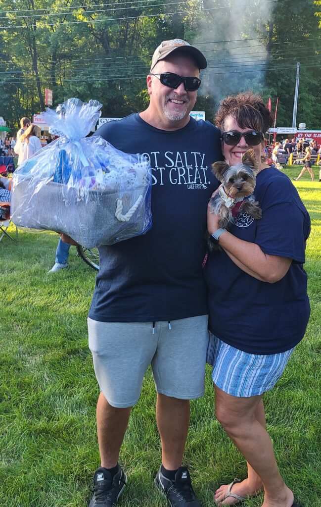 Luna, Winning Pooch in the 2022 Cutest Pooch contest with owners.