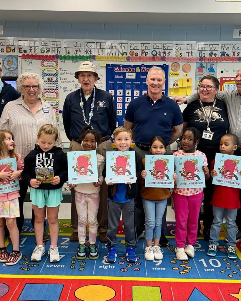Volunteers and students displaying books