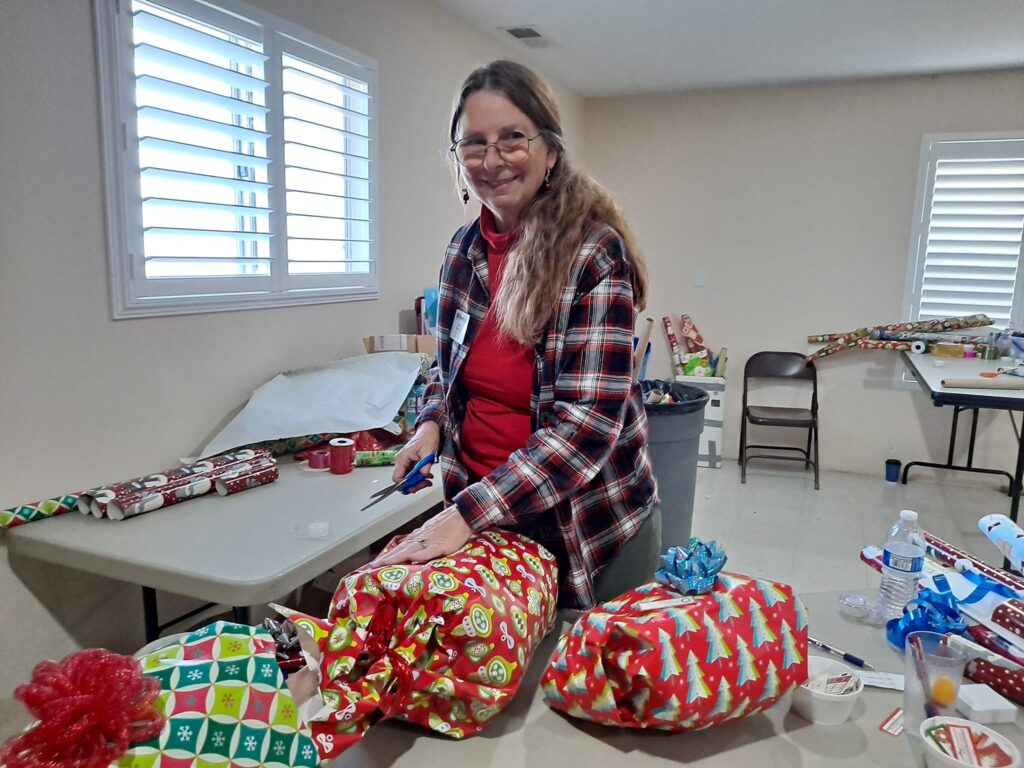 Laura Manser wrapping gifts at Toys for Joy, Dec 2023