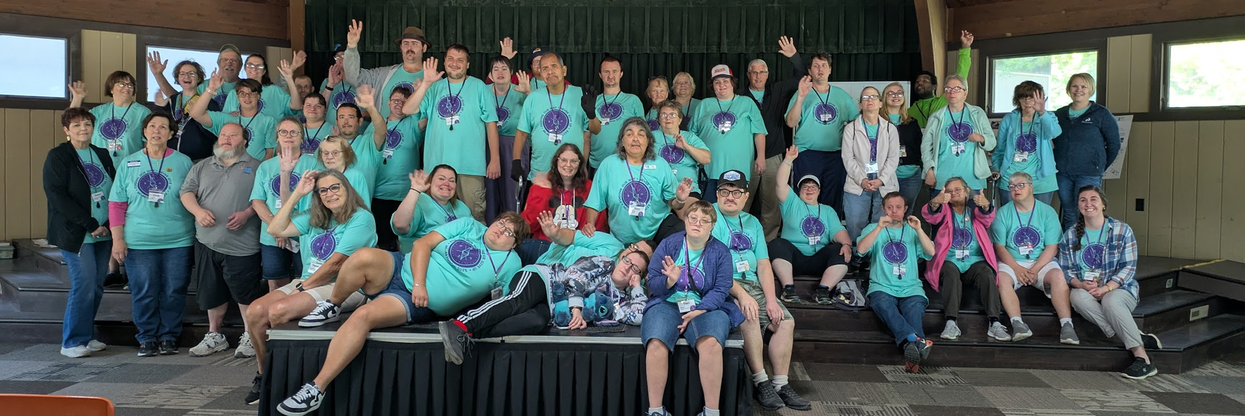 Aktion Club Convention attendees pose on stage