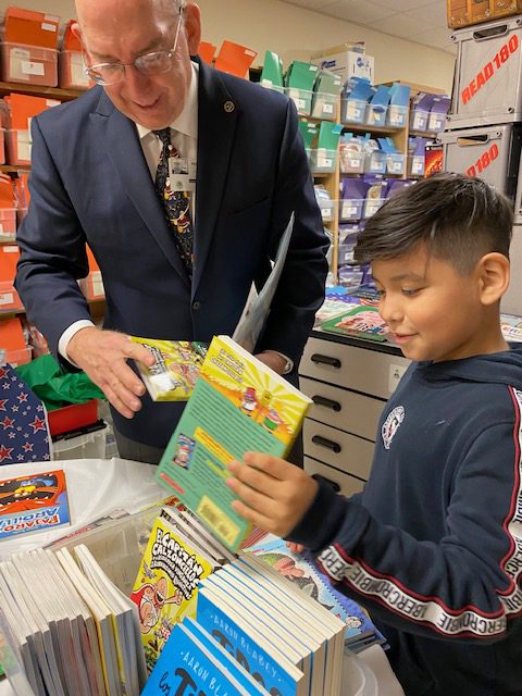 Elementary school Book give away - Kiwanian helping kids pick out new books