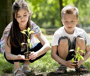 Kids planting trees is an example of Tecumseh Kiwanis projects that help develop student volunteerism and leadership.