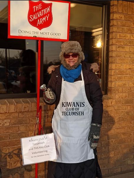 Kiwanis member rings Salvation Army bell.