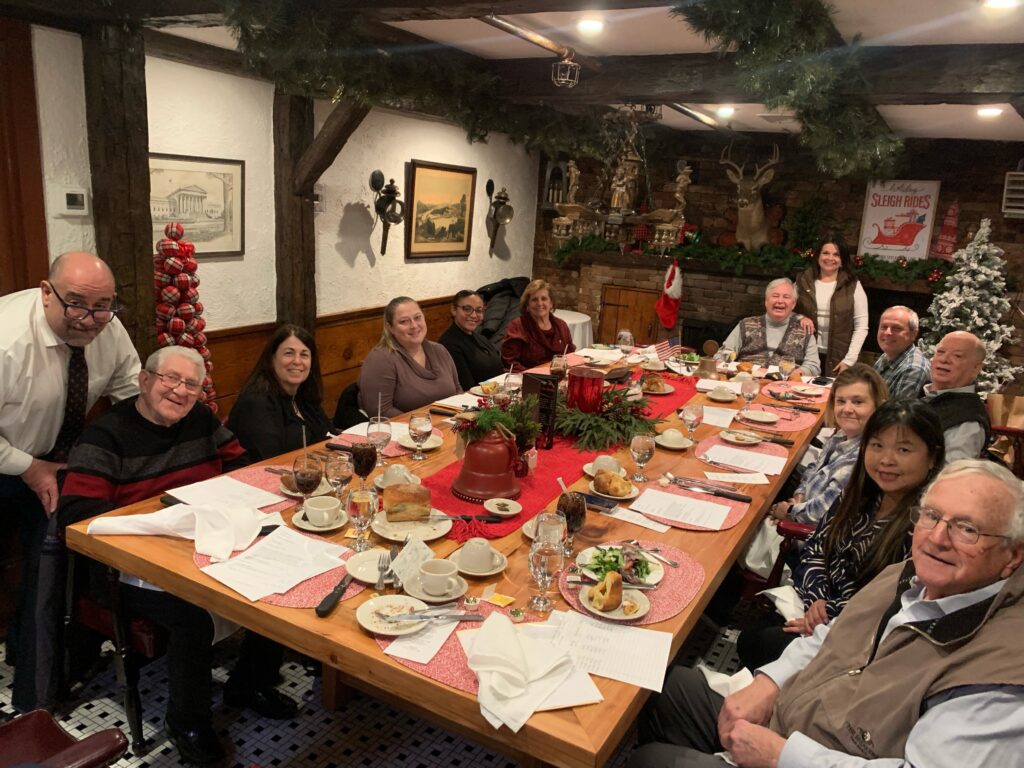 January 2025 - Monthly meeting group photo by the table