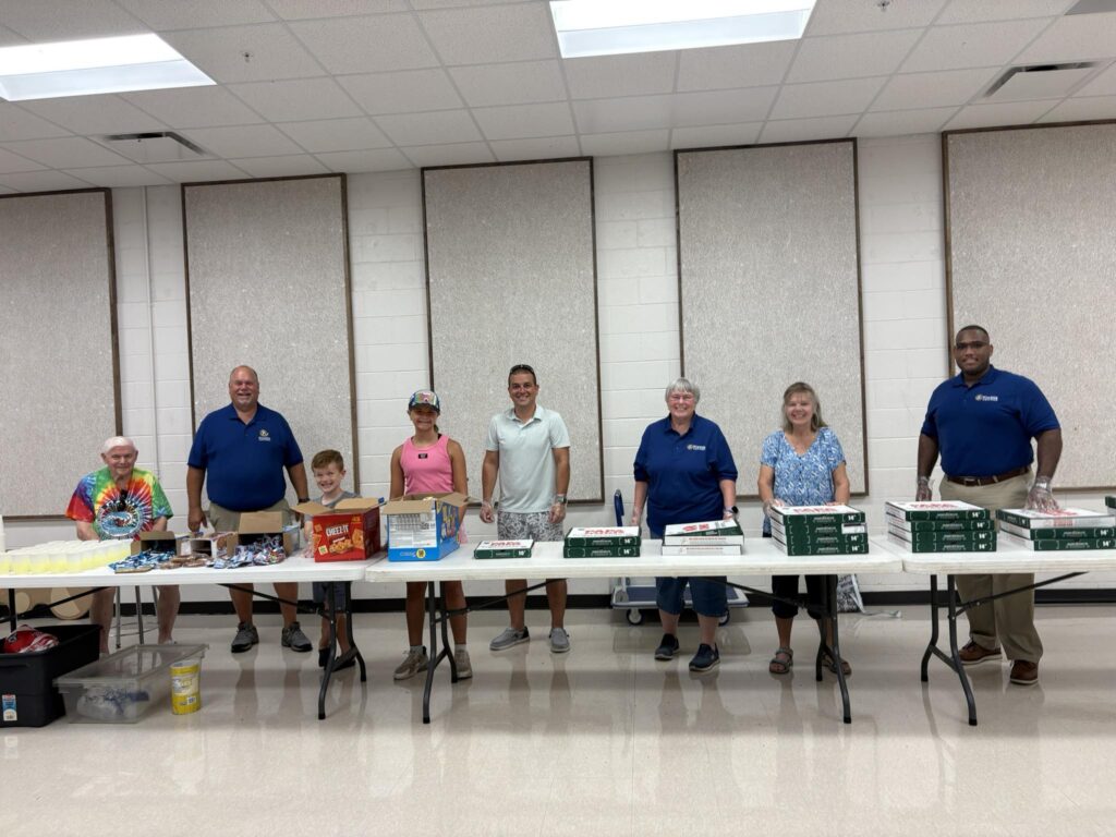 Kiwanis members serving lunch to HS band