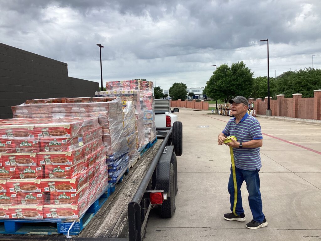 A Wolfe City Kiwanis Club Member picking up food for Hunt County Shared Ministries (FISH) to be used for their various programs including Meals for At Risk Kids (MARK) which provides food for school age children over the weekend