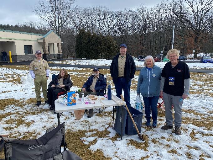 A group of people standing outside in the snow

Description automatically generated