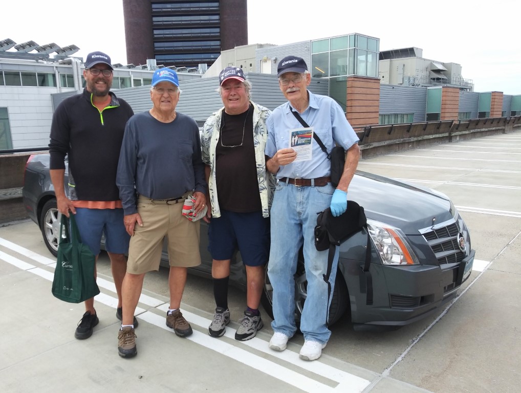 Reservoir Run flyer distribution team in front of a car.