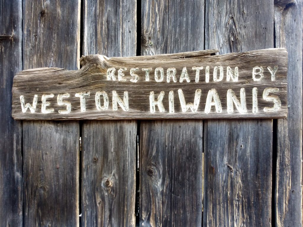 Sign attributing restoration of the onion barn to Weston Kiwanis.