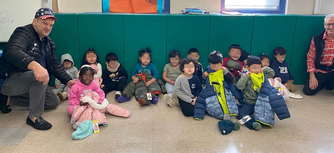 Kiwanians with children with their new winter coats at Norwalk Head Start.