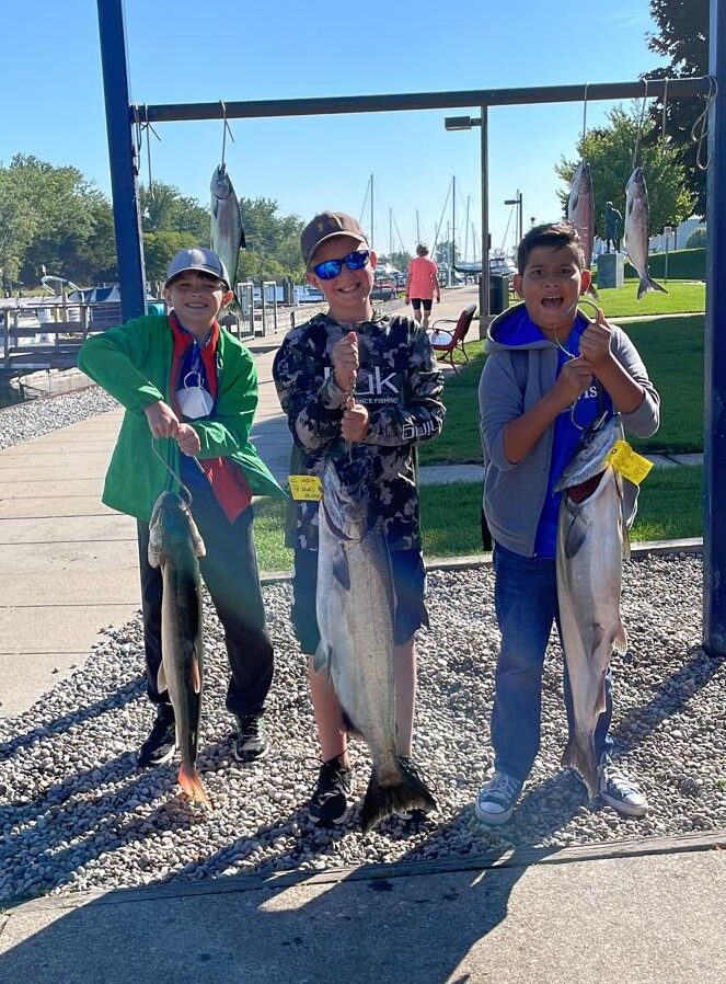 Three youth with fish