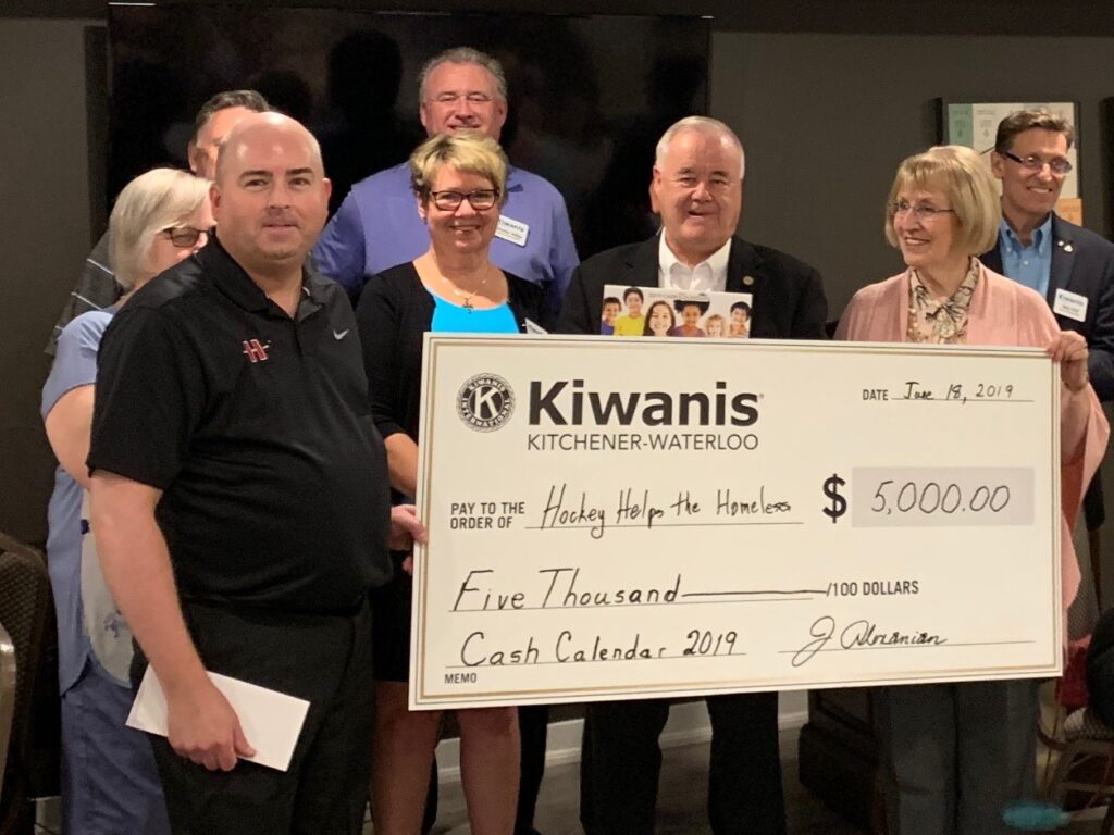 K-W Kiwanians present a cheque for $5000 to the Hockey Helps the Homeless organization