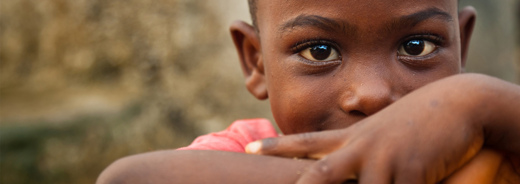 Young African boy smiling with arms folded