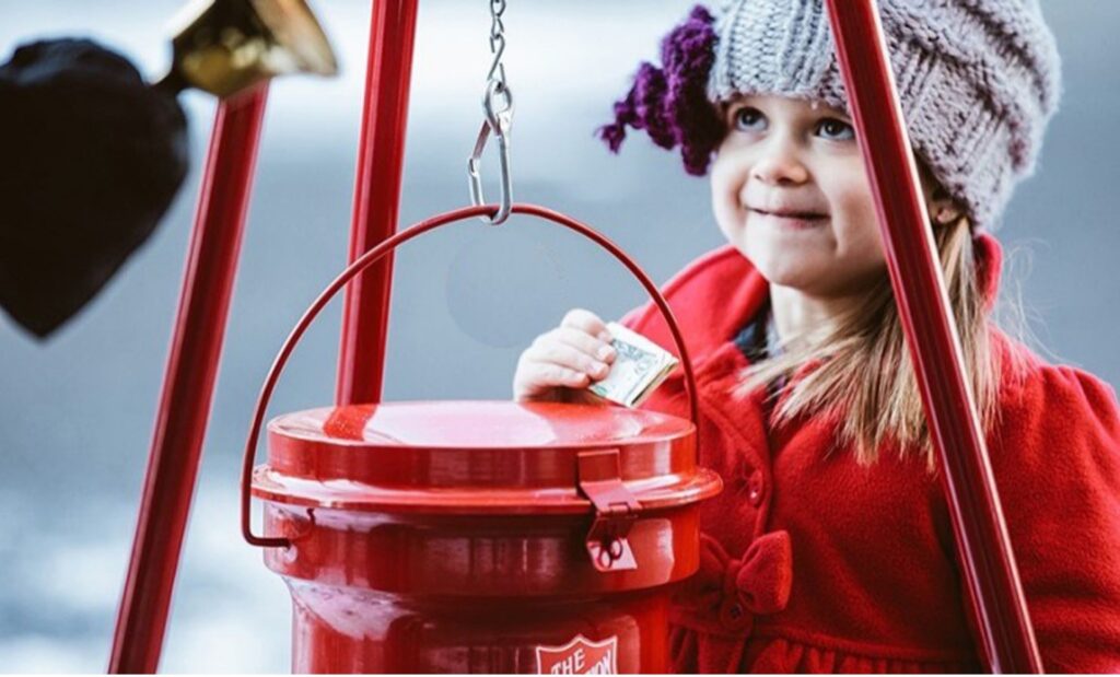 Little girl participating in the Annual Salvation Army Kettle Drive.