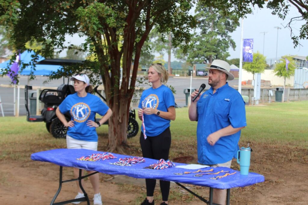 Kiwanis volunteers in blue club shirts at the event table