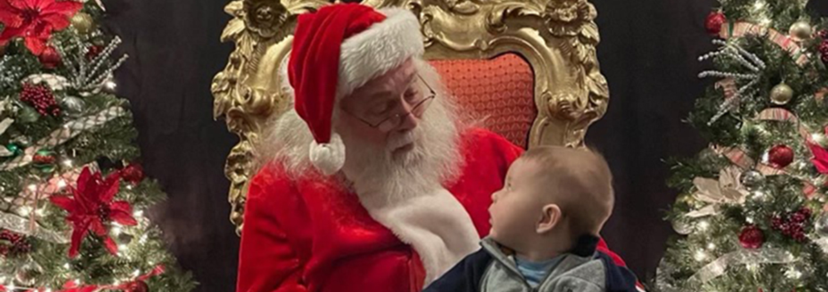 Santa with a small child, looking at each other